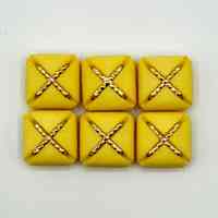 Set of six matching square buttons, yellow with golden "X" motif