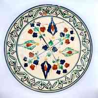 Hand-painted decorative earthenware plate, repaired