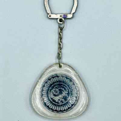 Keychain with clear plastic fob enclosing a goat emblem