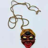 Ceramic face pendant, Afro-Cuban woman in a headscarf, on fiber cord