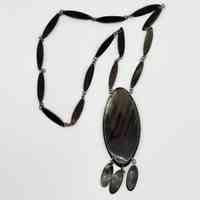 Horn necklace with linked navette plaques and oval pendant