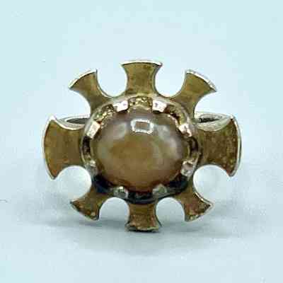 Ring with radiating sunburst setting and honey-colored cabochon