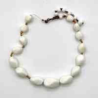 Single-strand white bead necklace with gold-tone spacers