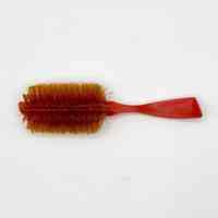 Plastic hairbrush with synthetic bristles, red