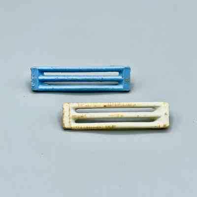Pair of barrette clip-bodies (arched slotted bars, hinge pin/spring missing)