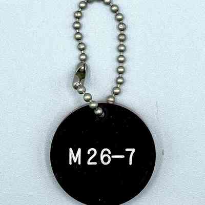 Double-sided "M 26-7" keychain fob (Movimiento 26 de Julio)