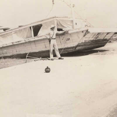 Standing in front of boat on road