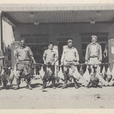 A Group of Men in front of Gas Station