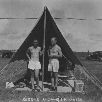 Men standing in front of tent