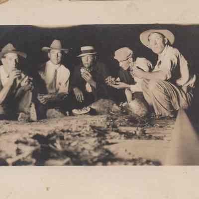 A group of young men with a sandwich