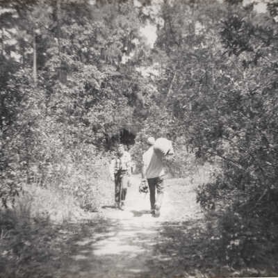 Boys hiking and carrying camping gear