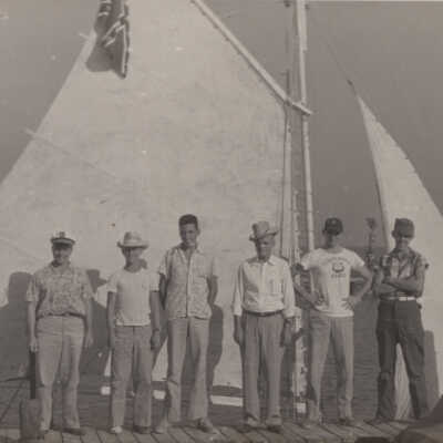 Men standing in front of boat