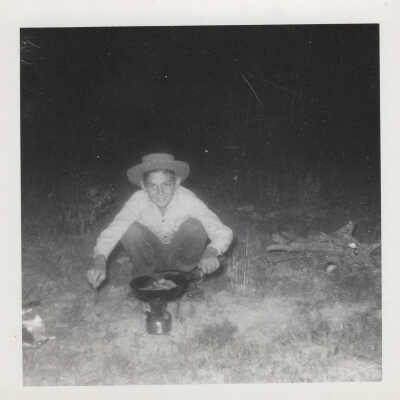 Boy setting up campfire