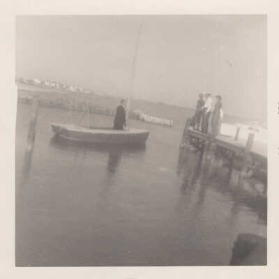 Man on boat heading to pier