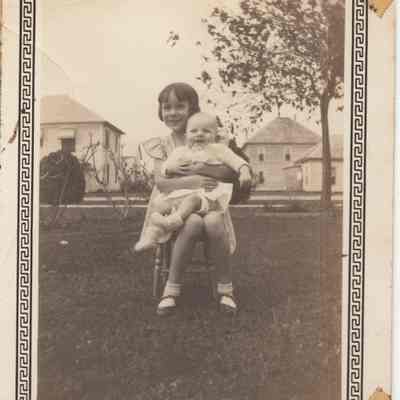 Claire Joy holding Buddy in a chair