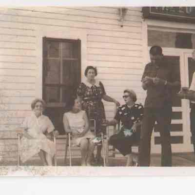 People on the front porch of the Luther Hotel