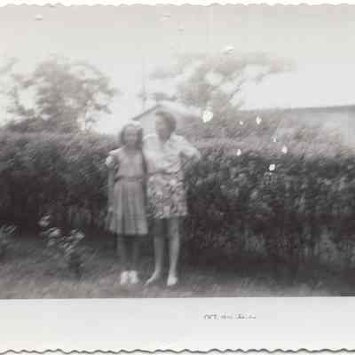 2 Women standing in the yard