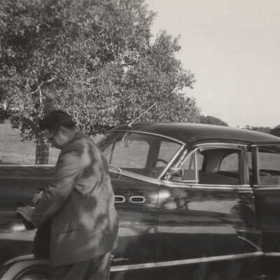 Man writing note on car