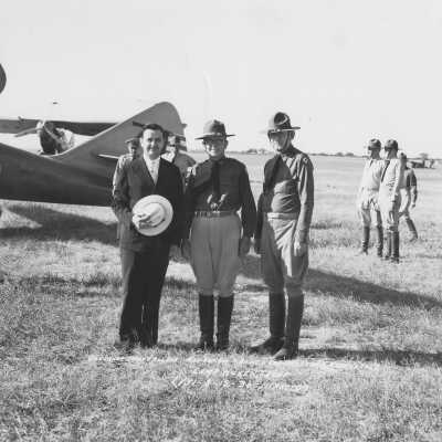 3 Men standing in front of planes at Camp Hulen, Texas
