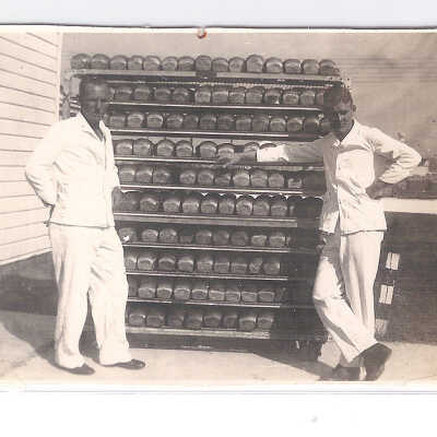 Two bakers and a Rack of Bread