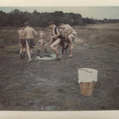 Boys dancing around camp fire