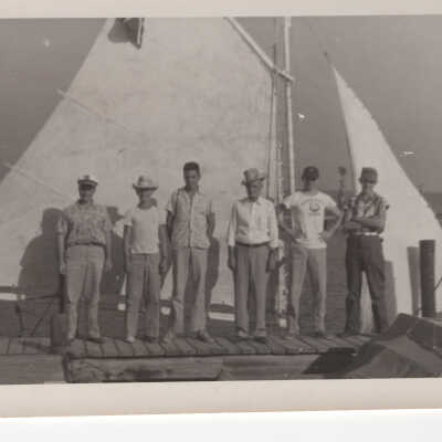 Men standing in front of boat