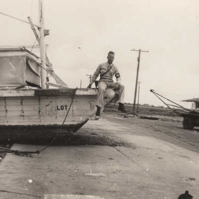 Soldier sitting on boat on road