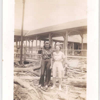 2 Ladies standing on debris