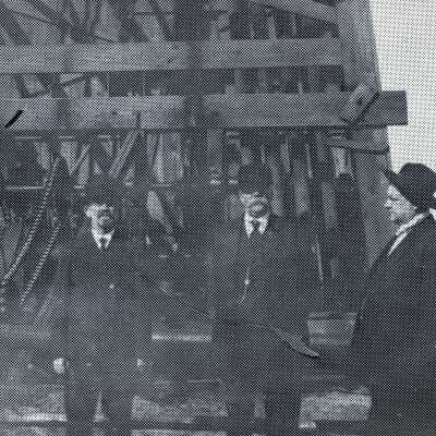 Men standing in front of Oil Well