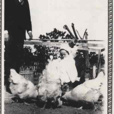 Charles and a toddler Claire Joy feeding chickens
