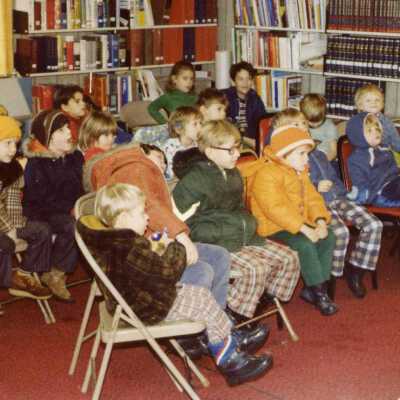 Watching a puppet show at the Tri-County Library