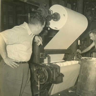 Lew Ravilious and Parker Baldwin operating the Crowell Tape Mill laminator