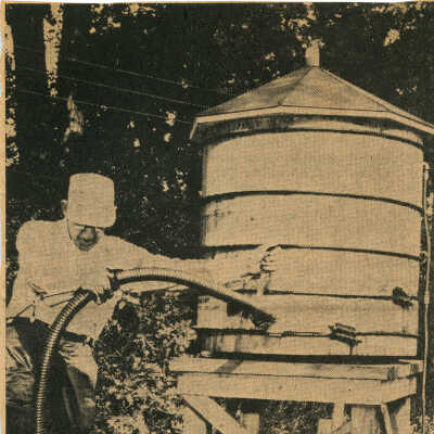 T. Clarence Marshall drawing water from tank