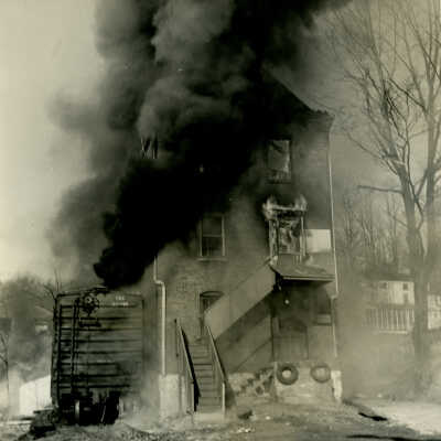 Crowell Tape Mill on fire viewed from the south looking north, 1964