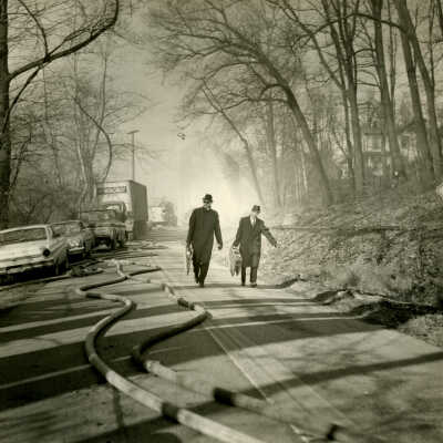 Herb Adelman and another man walking south of Crowell Tape Mill on Route 82 during fire, 1964