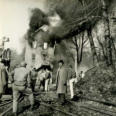 Crowell Tape Mill on fire with workers and bystanders, 1964