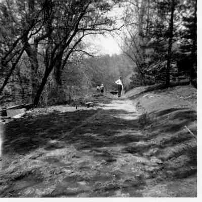 T Clarence Marshall surveying the right-of-way near the present location of the pond, 1960
