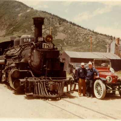 1982 Transcontinental Tour - Bob Reilly and Thomas C Marshall, Jr. with 1912 Stanley Model 87 and steam train in Silverton, CO