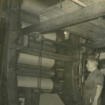 John Kosak operating the Crowell Tape Mill calendar to finish spit paper