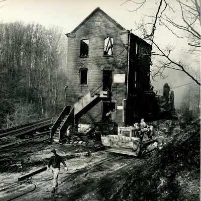 Crowell Tape Mill clean-up with hi-loader after the fire, 1964