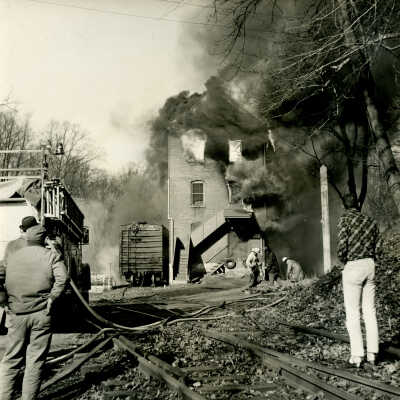 Crowell Tape Mill on fire with bystanders, 1964