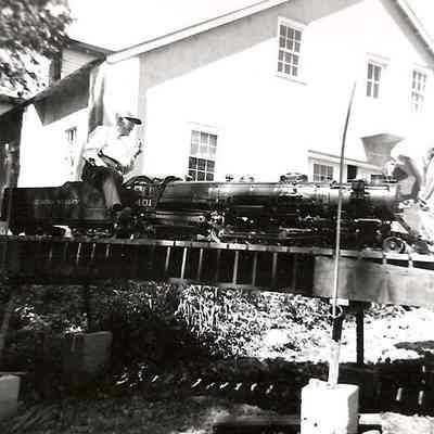 T Clarence Marshall easing the 401 across the trestle behind the museum, 1960