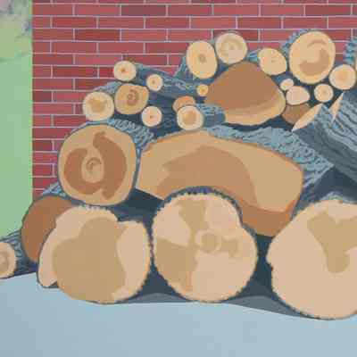 Log Pile Against Brick Wall