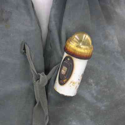 light (2024.1013.49.2) fastened to kapok life jacket (2024.1013.49.1)