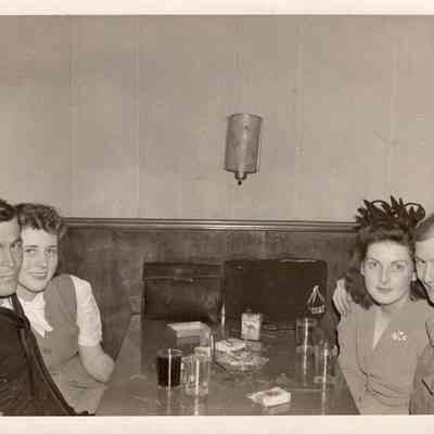 Sailor, soldier, and women at table