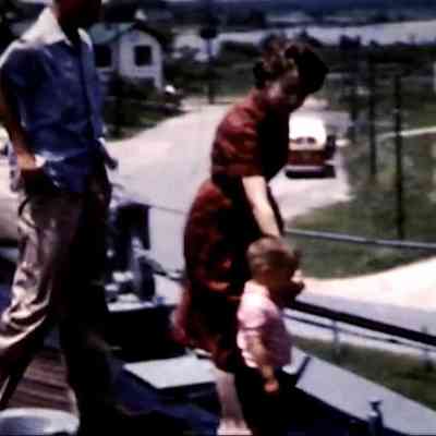 frame of family looking over railing in 2025.1019.70: 7:44 time stamp