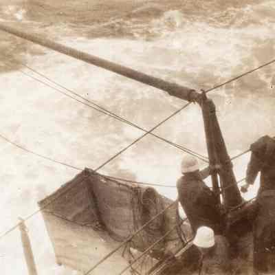 Sailors looking over rough seas