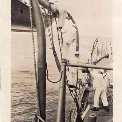 Sailors hoisting boat