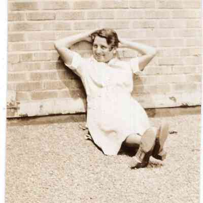 Woman relaxing on brick wall