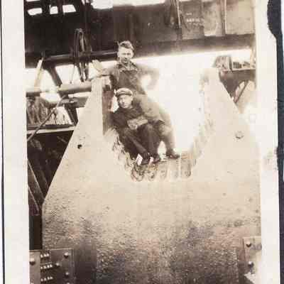 Men pose in mill